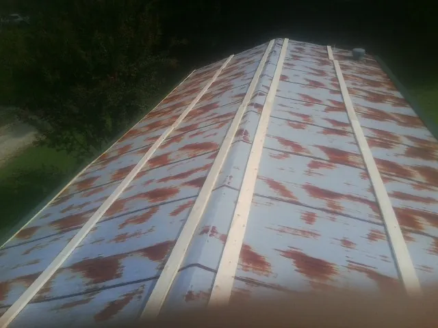 Rusted metal roof panels with new wood purlins before replacement — Storm Damage Roof Repair in Shady Side by Roofing Brothers